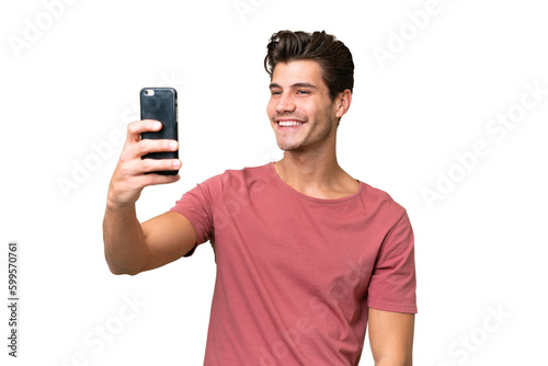 Young handsome caucasian man over isolated background making a selfie © luismolinero