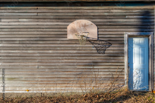 abandoned basketball net on the side of a barn