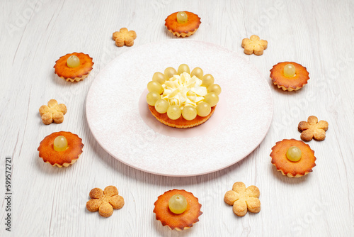 front view yummy little cakes lined on white background dessert biscuit tea cake pie sweet cookie