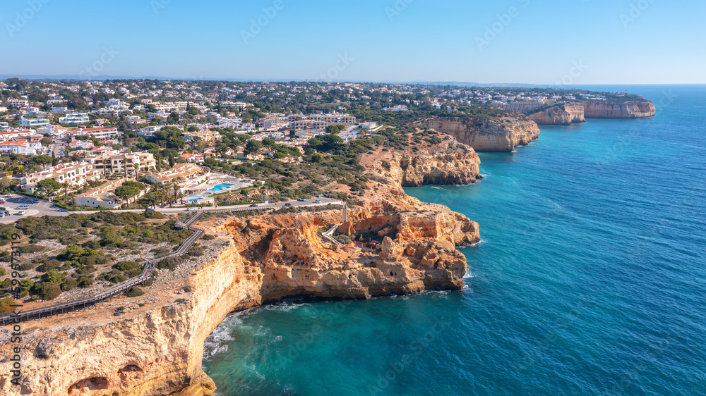 Aerial view of the rocky shores of the village of Carvoeiro in the southern zone of the Algarve. wooden walkways