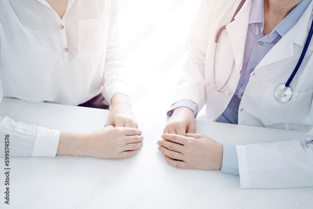 Stethoscope lying on the tablet computer in front of a doctor and patient sitting opposite each other at the background . Medicine, healthcare concept Stethoscope lying on the tablet computer in front of a doctor and patient sitting opposite each other at the background . Medicine, healthcare concept