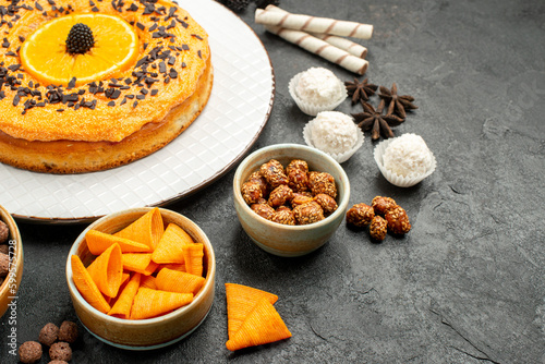 front view yummy sweet pie with orange slices on dark-grey background dough fruit pie cake biscuit