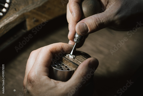 Craft jewelery making. Repairing jewel by inlaid tight gem.