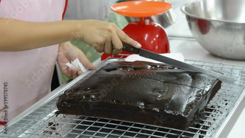 close up female hands cutting chocolate bread