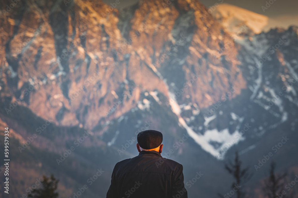 old man looking at the mountains