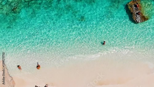 Cala Goloritze Sardinia Beach Sardinia Italy, a beautiful beach full of beach umbrellas and people sunbathing and swimming in the turquoise water Sardinia, Italy Golfo Di Orosei during summer photo