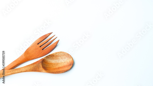 Wooden spoon and fork isolated on white background. Kitchen and cooking concept.