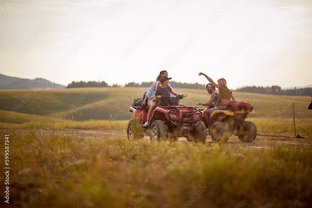 Obraz premium Group of energetic friends driving quads together