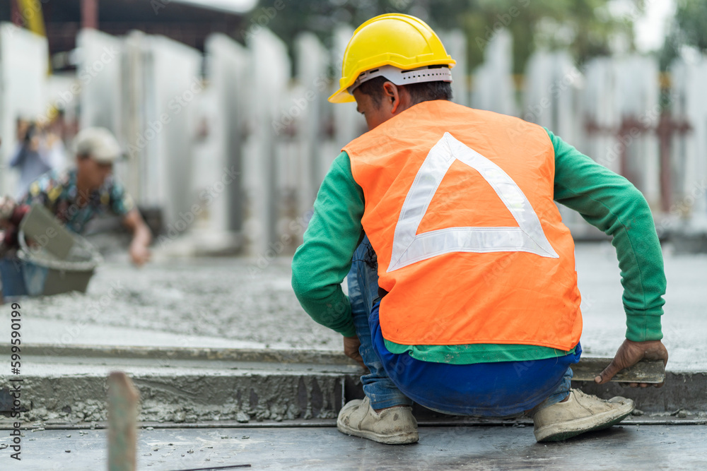 Male worker in a precast wall factory (Precast) is forming a wall with cement. and smooth the plaster in the prepared mold Male worker in a precast wall factory (Precast) is forming a wall with cement. and smooth the plaster in the prepared mold