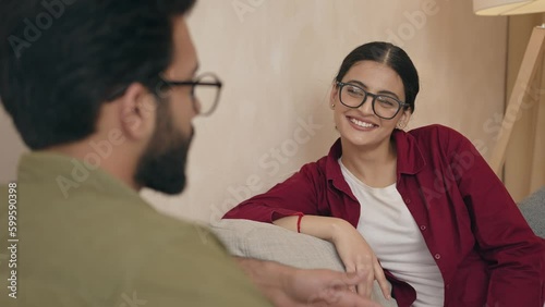 Happy joyful married couple resting on comfortable couch together