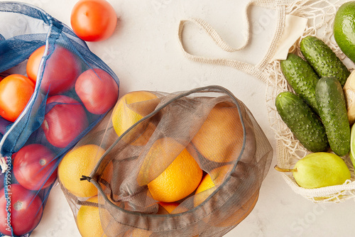  Reusable eco friendlyl bags with fruits and vegetables groceries. Zero waste, sustainable lifestyle. Top view