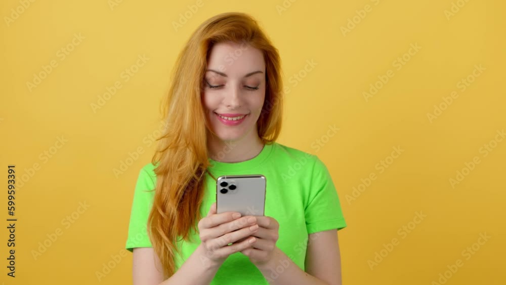 Woman smiling, phone scroll, happiness and swiping on online dating app. Mobile smartphone chat wifi and happy female blonde lady for social media and internet, studio isolated on yellow background Woman smiling, phone scroll, happiness and swiping on online dating app. Mobile smartphone chat wifi and happy female blonde lady for social media and internet, studio isolated on yellow background