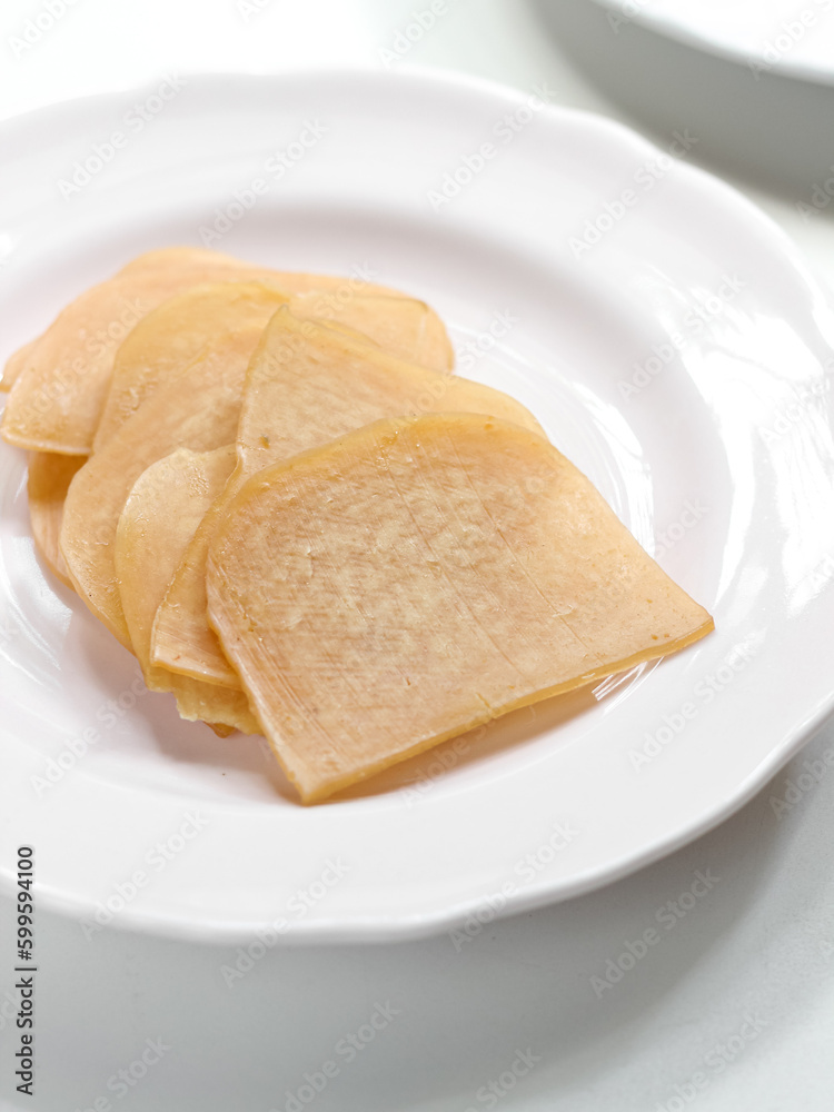 Kerupuk Udang Mentah or Raw Shrimp Crackers in white plate Kerupuk Udang Mentah or Raw Shrimp Crackers in white plate