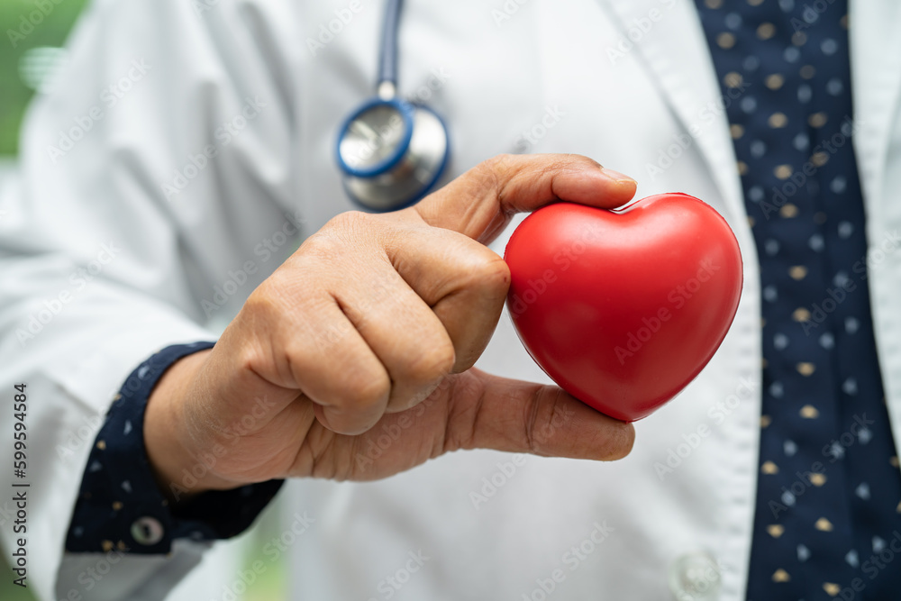 Doctor holding a red heart in hospital ward, healthy strong medical concept. Doctor holding a red heart in hospital ward, healthy strong medical concept.