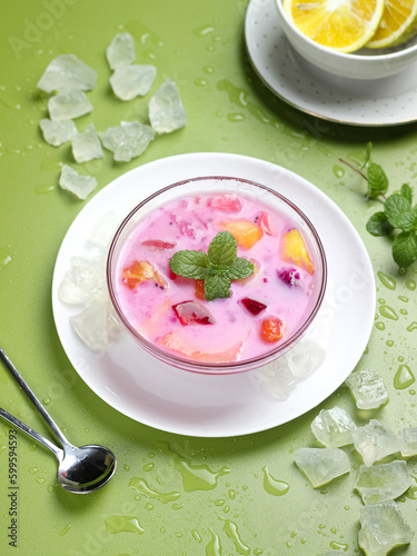 sop buah or fruit soup is indonesian fruit cocktail ice made from various diced fruits mixed with ice cubes, condensed milk and red syrup. popular food for breakfasting