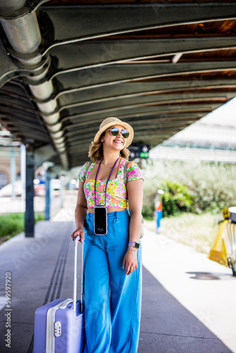 woman is looking at arriving train at a railway station