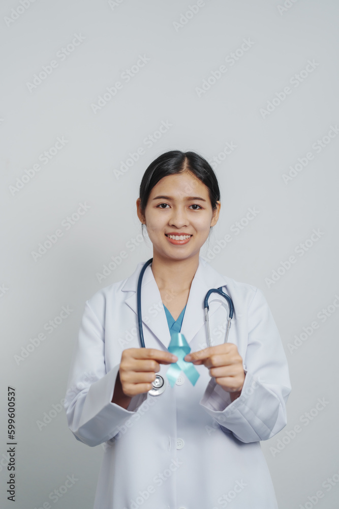 Doctor asian female specialist holding blue ribbon and stethoscope and Breast cancer awareness concept Doctor asian female specialist holding blue ribbon and stethoscope and Breast cancer awareness concept