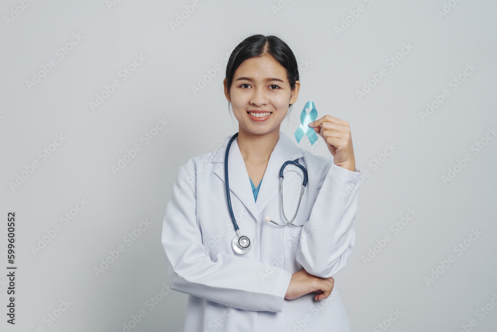 Doctor asian female specialist holding blue ribbon and stethoscope and Breast cancer awareness concept Doctor asian female specialist holding blue ribbon and stethoscope and Breast cancer awareness concept