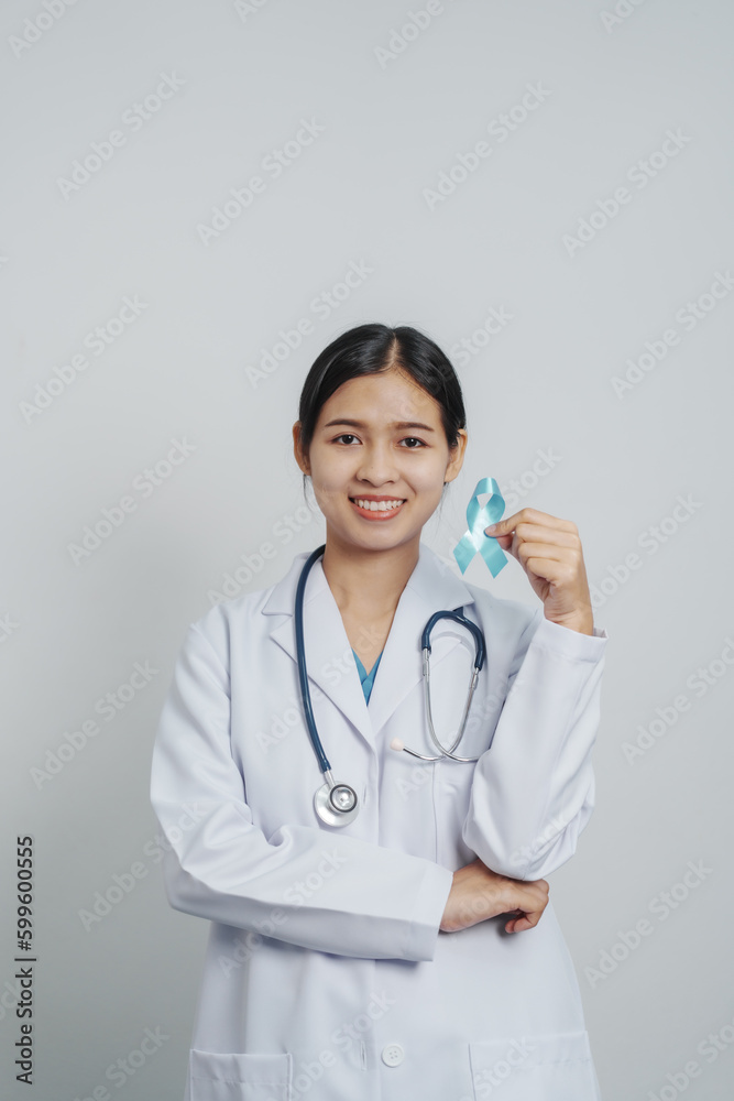 Doctor asian female specialist holding blue ribbon and stethoscope and Breast cancer awareness concept Doctor asian female specialist holding blue ribbon and stethoscope and Breast cancer awareness concept