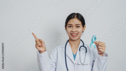 Doctor asian female specialist holding blue ribbon and stethoscope and Breast cancer awareness concept