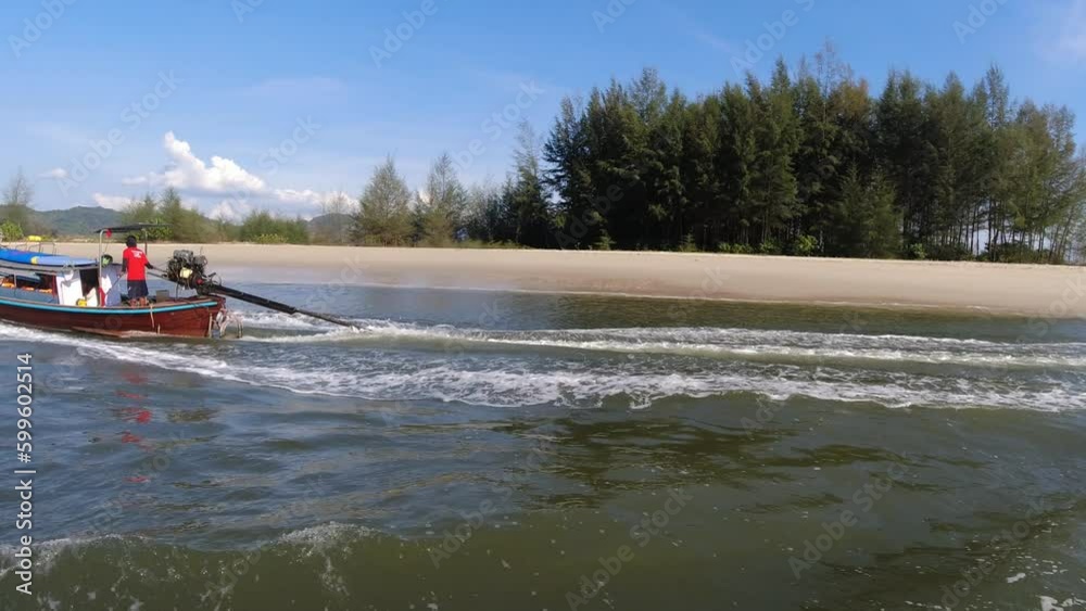 Longtail boat navigating in Thailand coasts Longtail boat navigating in Thailand coasts
