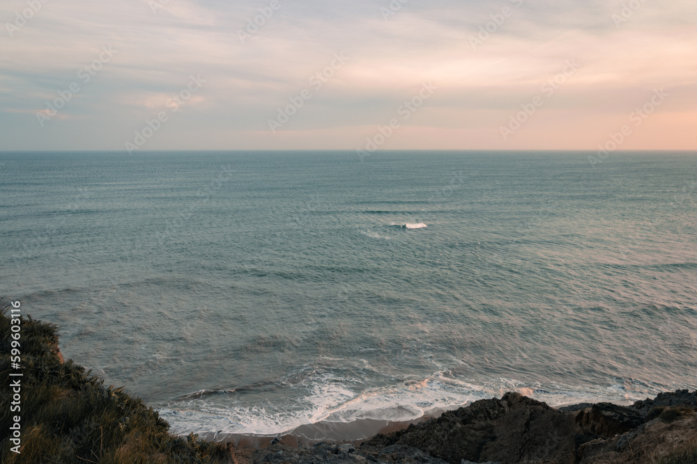The ocean at sunset, view from a clifftop
