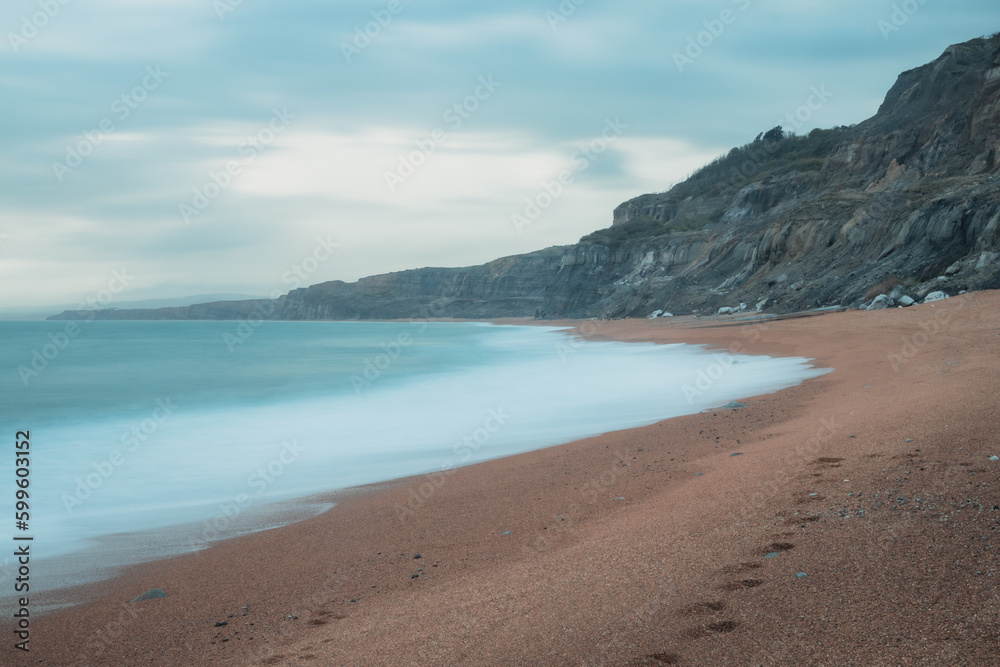 Long exposure of a beautiful empty coastline on a cloudy day Long exposure of a beautiful empty coastline on a cloudy day