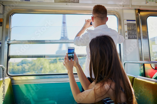 Photography Couple traveling in subway train with view to the Eiffel tower
