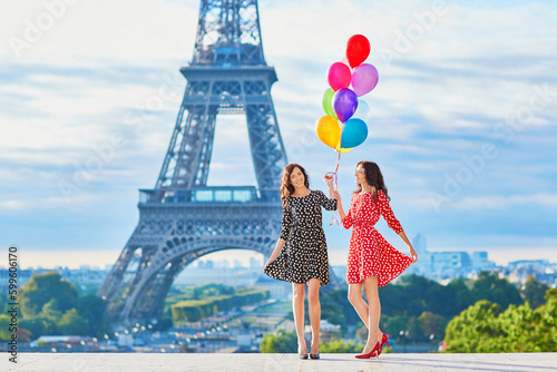Beautiful twin sisters with colorful balloons © Ekaterina Pokrovsky