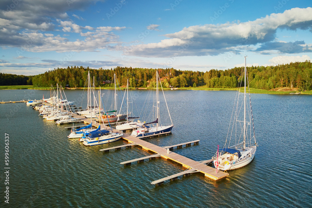 Scenic aerial view of colorful boats near wooden berth Scenic aerial view of colorful boats near wooden berth