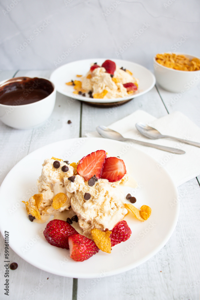 Ice cream with strawberries and chocolate drizzle. On a wooden background. Dessert
Ice cream with strawberries and chocolate drizzle. On a wooden background. Dessert