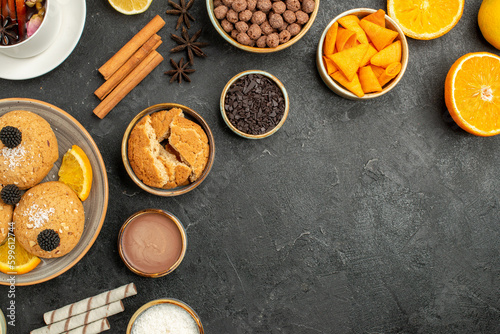 top view yummy cookies with cup of tea and orange slices on a dark background cake pie sugar dessert biscuit tea