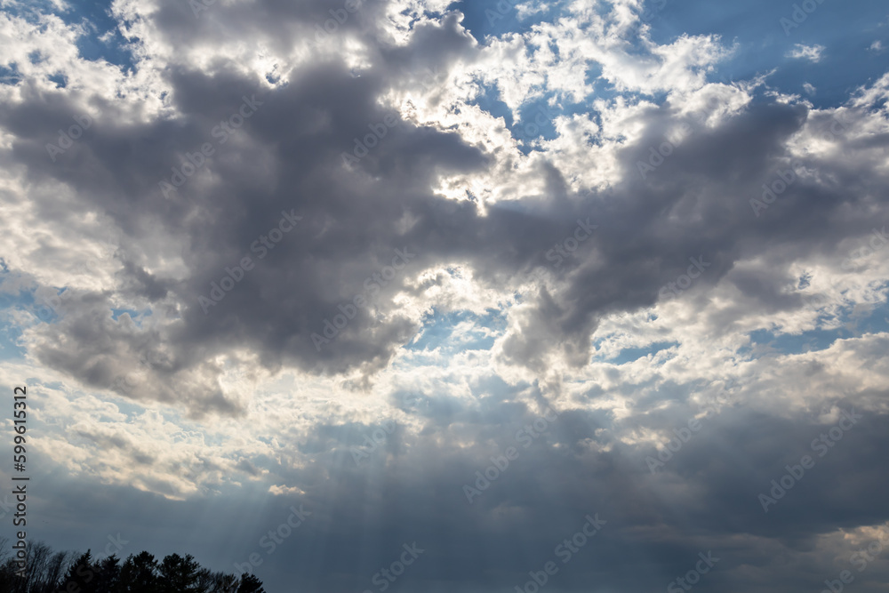 Looking up at gray clouds with silver lining against blue sky Looking up at gray clouds with silver lining against blue sky