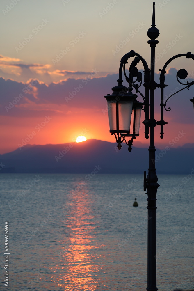 Sunset over lake with lantern