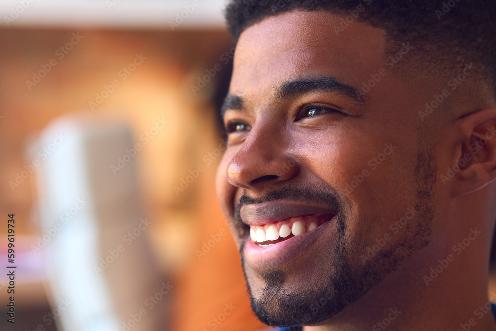 Close Up Portrait Of Smiling Young Businessman At Desk In Modern Office Close Up Portrait Of Smiling Young Businessman At Desk In Modern Office