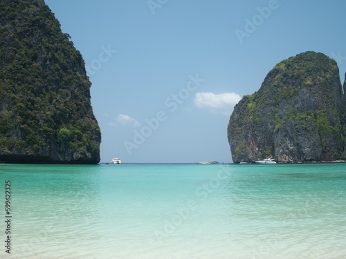  Maya Bay - Beautiful beach in Phi Phi Island there are motor boats of tourists in the distance. Situated in Hat Noppharat Thara in Thailand. Quiet atmosphere beautiful sea, white sand beach, 