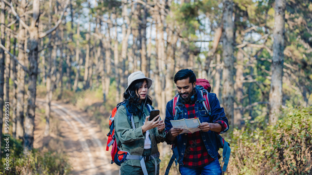 Fototapeta premium Happy Travelers Hiking with Backpacks on the Beautiful Rocky Trail at Warm Sunny. Hikers with backpacks walks in mountains. travel in the mountains with backpacks. Travel in the mountain with backpack