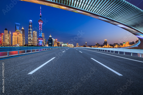 Straight asphalt road and city skyline with modern buildings in Shanghai  China.