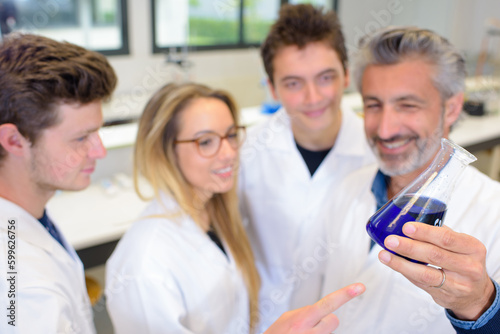 students and teacher inside the laboratory