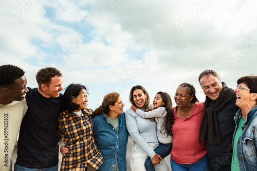 Happy multigenerational friends with different ethnicity having fun at house rooftop - Diversity people lifestyle