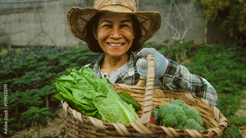 Happy southeast Asian woman working inside agricultural land - Farm people lifestyle concept