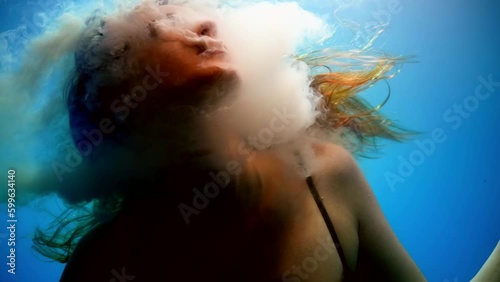 possessed by devil or demon woman diving in water depth, mysterious and fabulous underwater shot