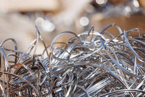 Steel scrap from CNC machine. waste aluminium trash. Steel shavings with industrial garbage background.