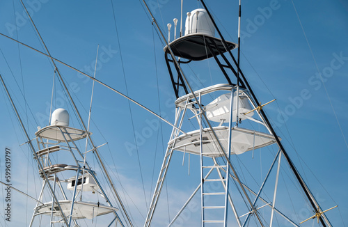 Tuna Towers of two sport fishing yachts moored next to each other in a marina. Used for spotting fish swimming near the waters surface.