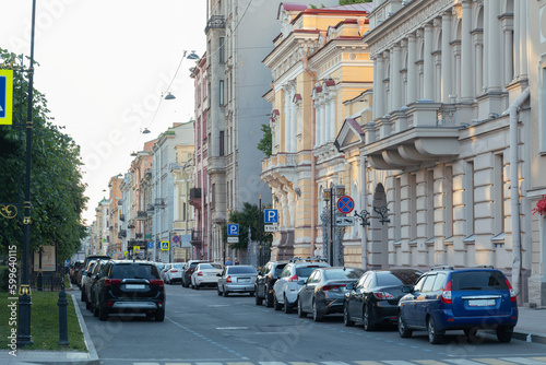 View of street with houses  cars and old buildings of city in the Saint Petersburg. City street on a summer evening