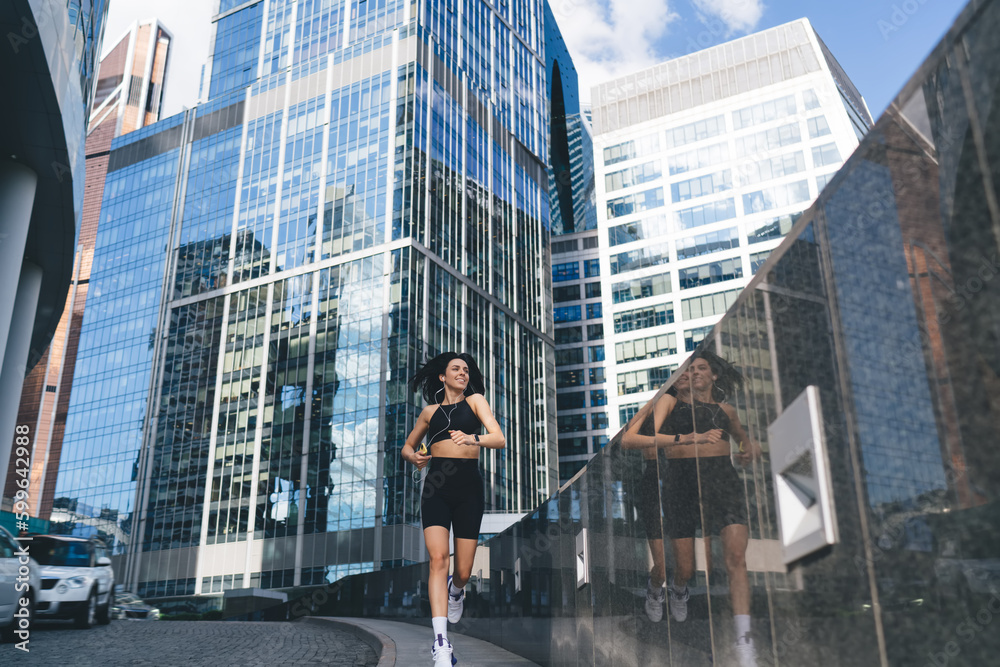 Content athletic lady jogging in megapolis