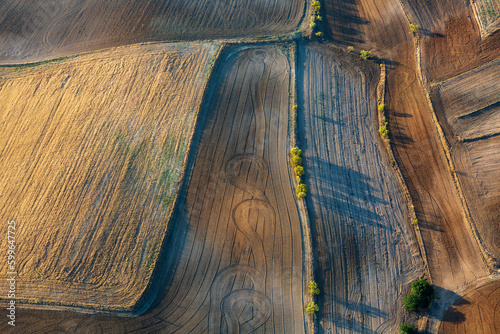 Vista aérea de un paisaje con cultivos arados al amanecer. photo