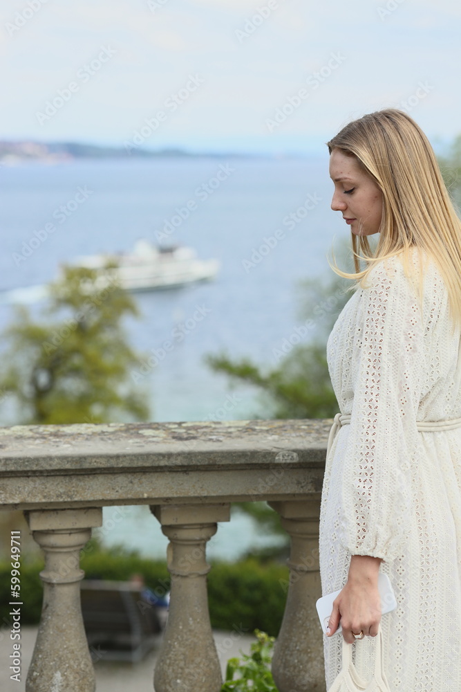 a girl in a white dress in the spring in the park, in a park on a sunny day, a young woman in white, a romantic mood, a blooming age, white clothes, a cotton dress, a girl with long blond hair,