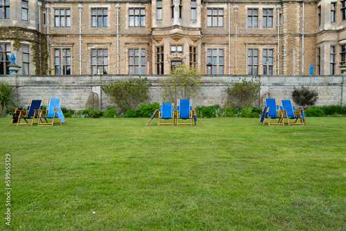 Obraz na plátne Shallow focus of a pair of canvas deck chairs seen in the grounds of a stately home