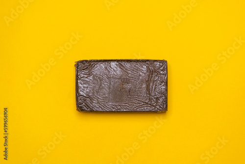 Chemdawg filtered hash. Medical marijuana extraction super dry hashish high quality cannabis pollen on a yellow background.